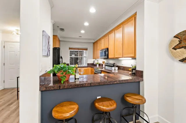 a kitchen with stainless steel appliances granite countertop a sink and a window