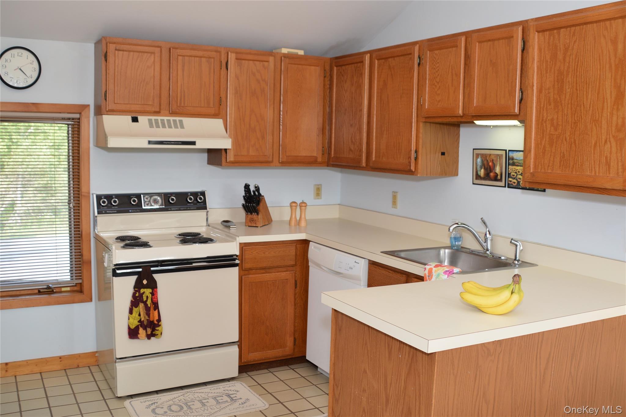 79 Windham Ridge Road, Unit 17A Windham, NY 12496 - Photo 3 of 18 a kitchen with a sink a stove and wooden cabinets