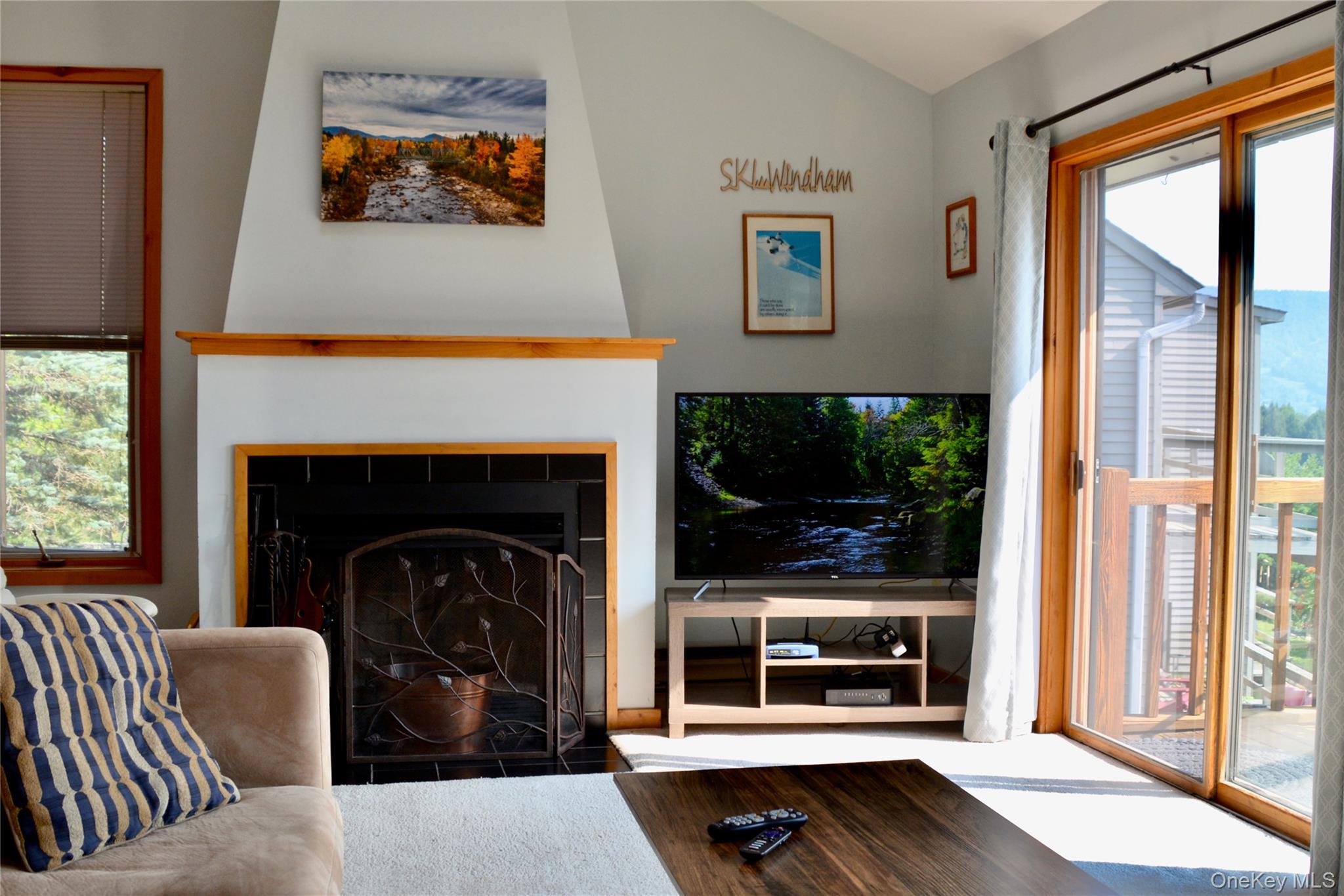 79 Windham Ridge Road, Unit 17A Windham, NY 12496 - Photo 5 of 18 a living room with furniture and a fireplace