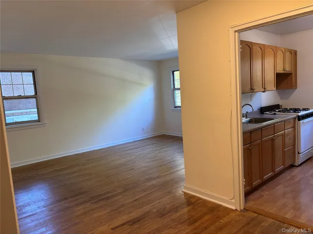 a view of a kitchen with wooden floor and electronic appliances