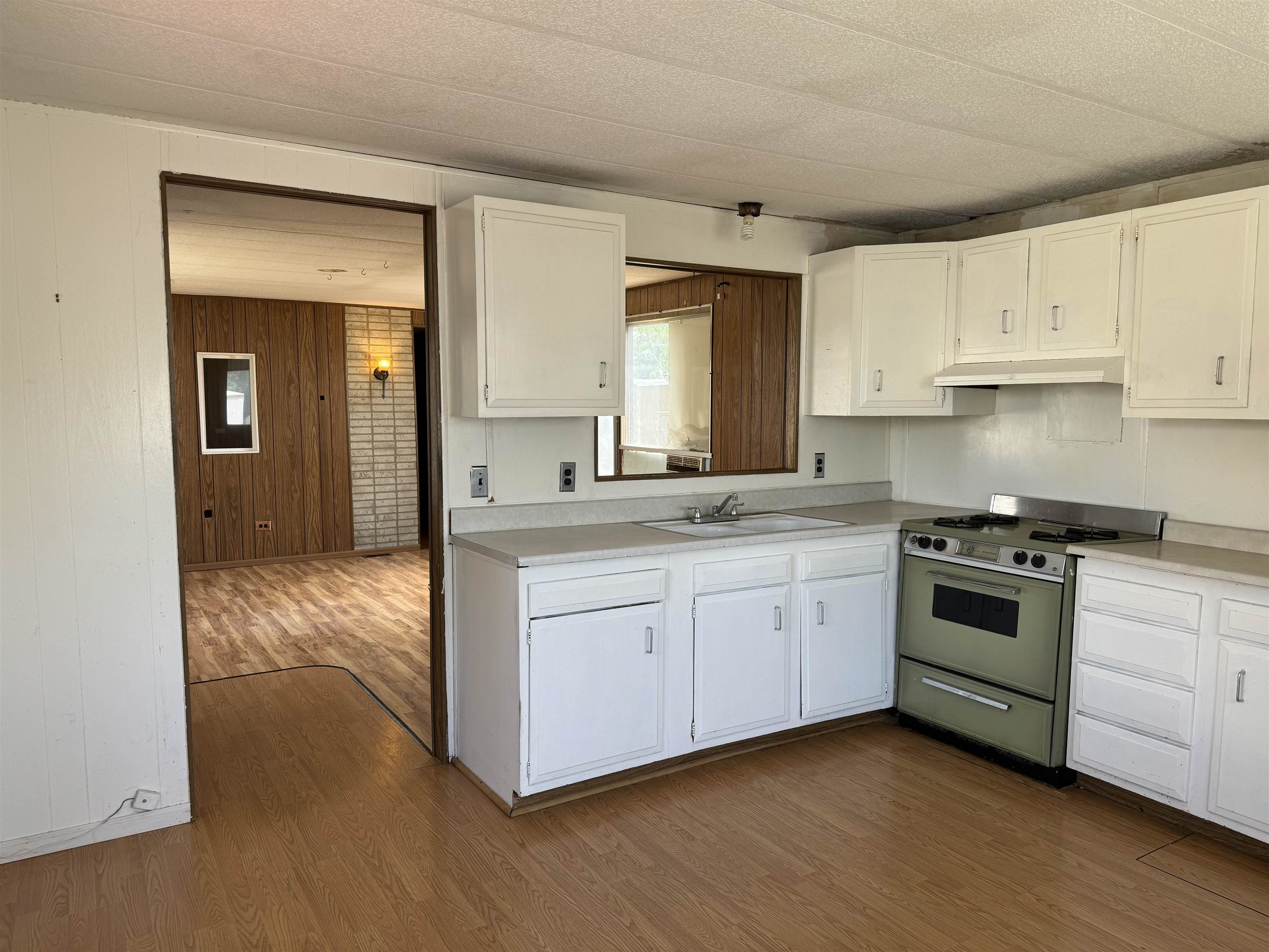 585-25 25 1/2 Road, Unit 215 Grand Junction, CO 81505 - Photo 7 of 15 a kitchen with granite countertop white cabinets and white appliances