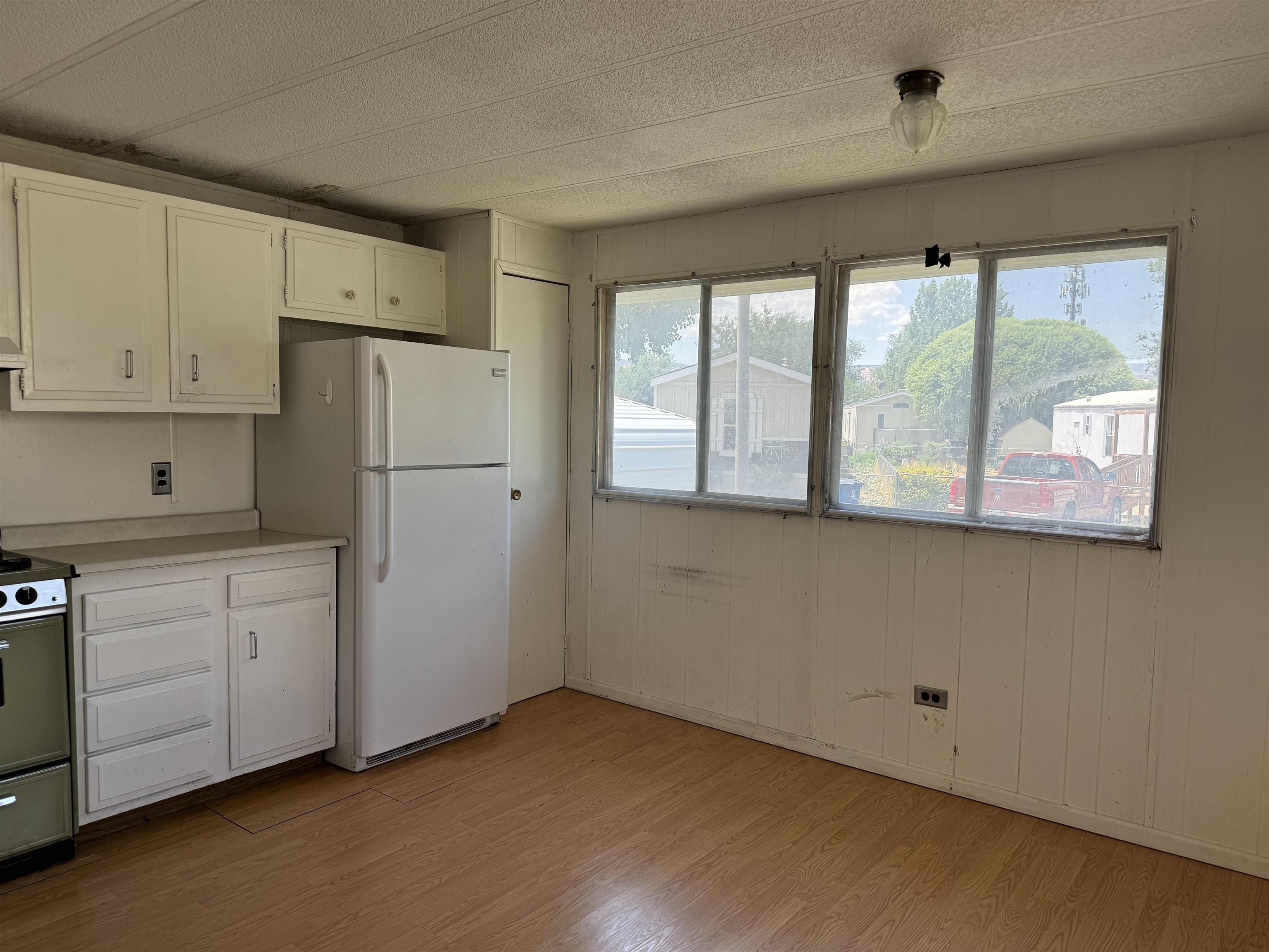 585-25 25 1/2 Road, Unit 215 Grand Junction, CO 81505 - Photo 8 of 15 a kitchen with white cabinets and a window