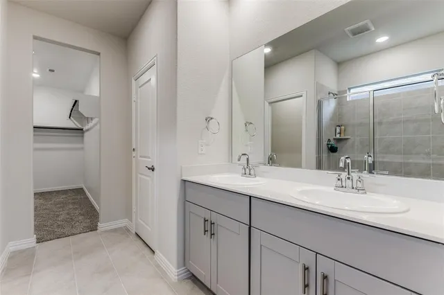 a bathroom with a shower and a glass door