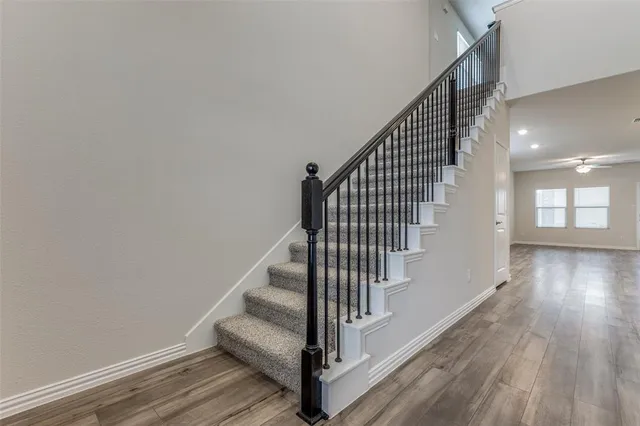 a view of entryway and hall with wooden floor