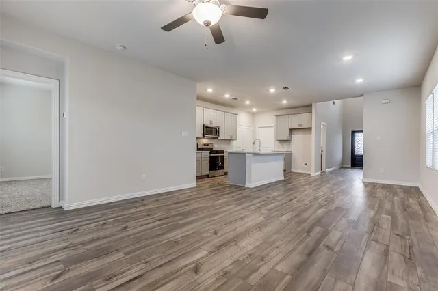 a view of kitchen with granite countertop cabinets and refrigerator