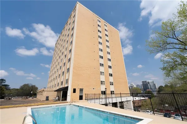 a view of a swimming pool with a patio and yard