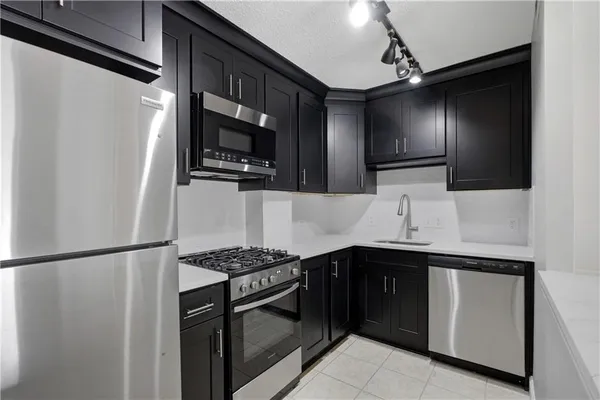 a stove top oven sitting inside of a kitchen