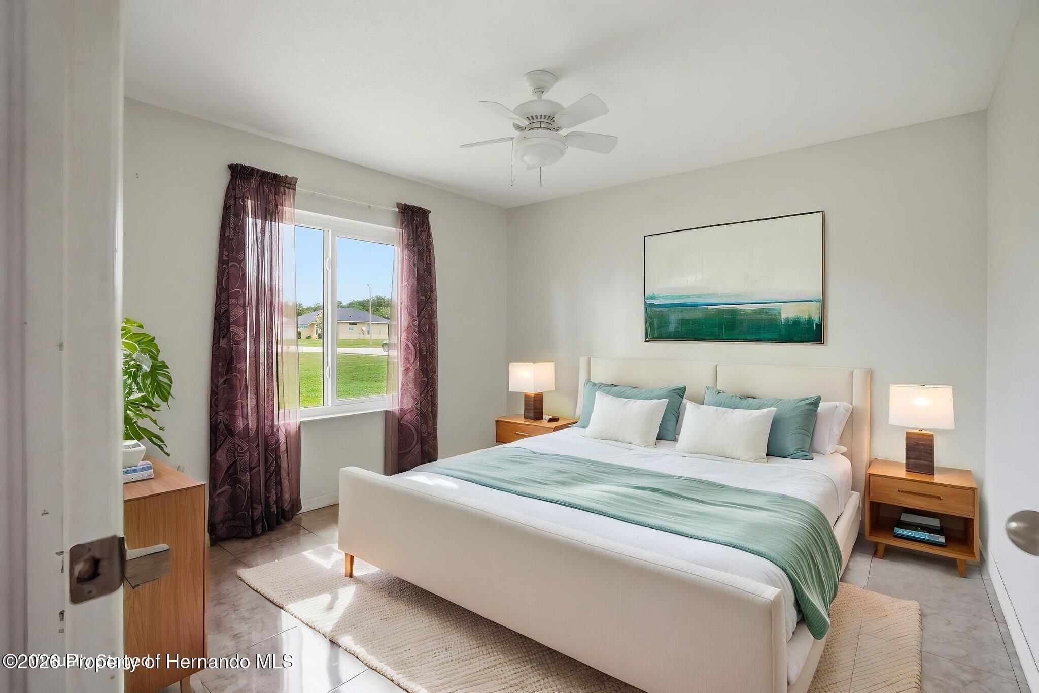 18131 Rivard Boulevard Brooksville, FL 34604 - Photo 33 of 66 a bedroom with a bed and a chandelier