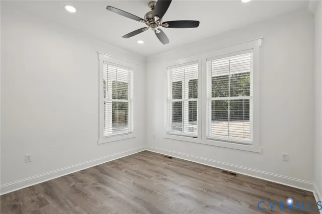 a kitchen with white cabinets and sink