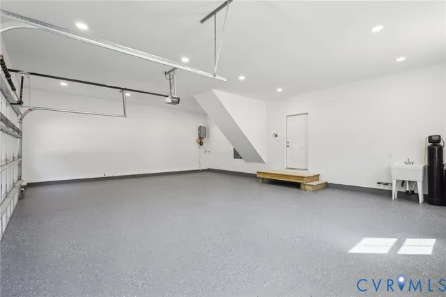 a bathroom with a tub a sink and a mirror