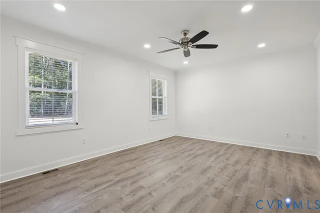 an empty room with windows and closet