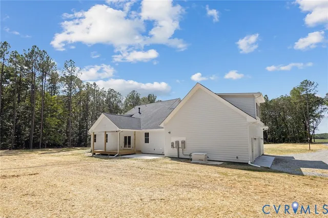 a view of a white house with a yard