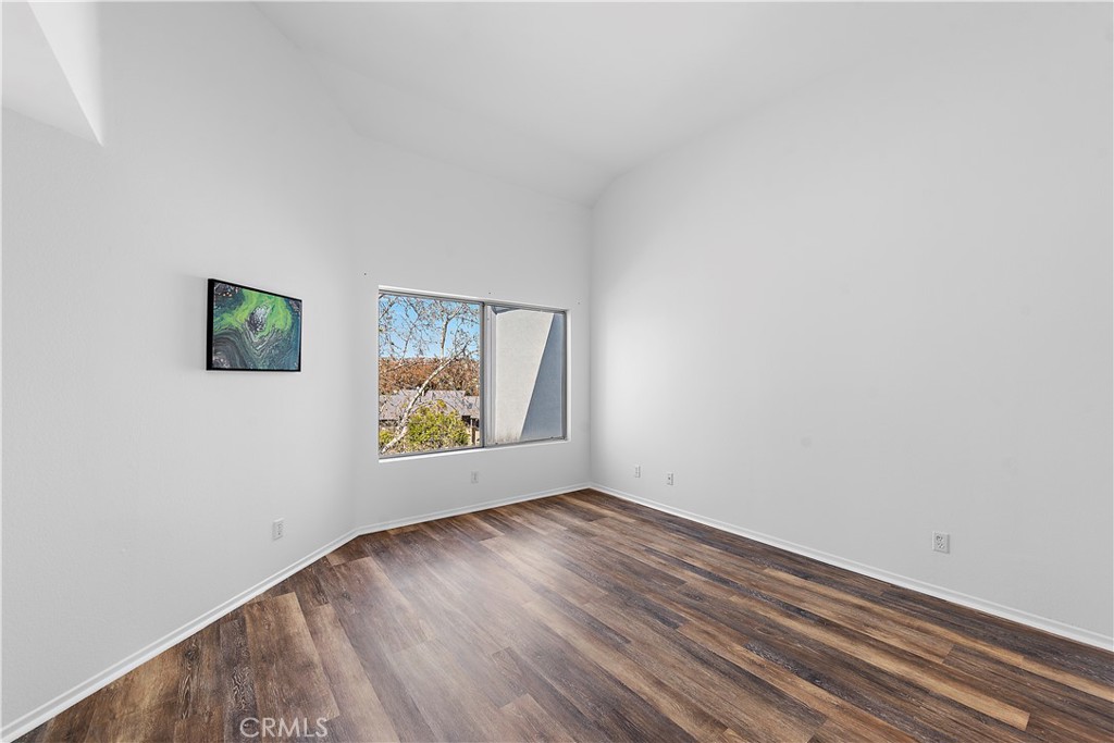 24451 Lantern Hill Drive, Unit D Dana Point, CA 92629 - Photo 11 of 32 an empty room with wooden floor and window