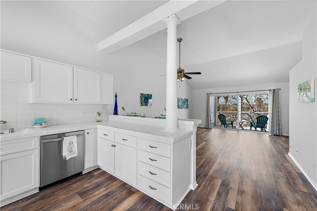 24451 Lantern Hill Drive, Unit D Dana Point, CA 92629 - Photo 6 of 32 a kitchen with white cabinets and wooden floors