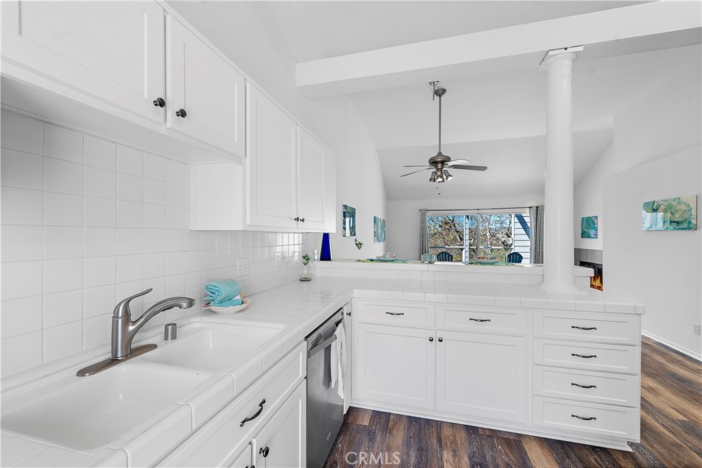 24451 Lantern Hill Drive, Unit D Dana Point, CA 92629 - Photo 9 of 32 a kitchen with cabinets appliances a sink and dishwasher