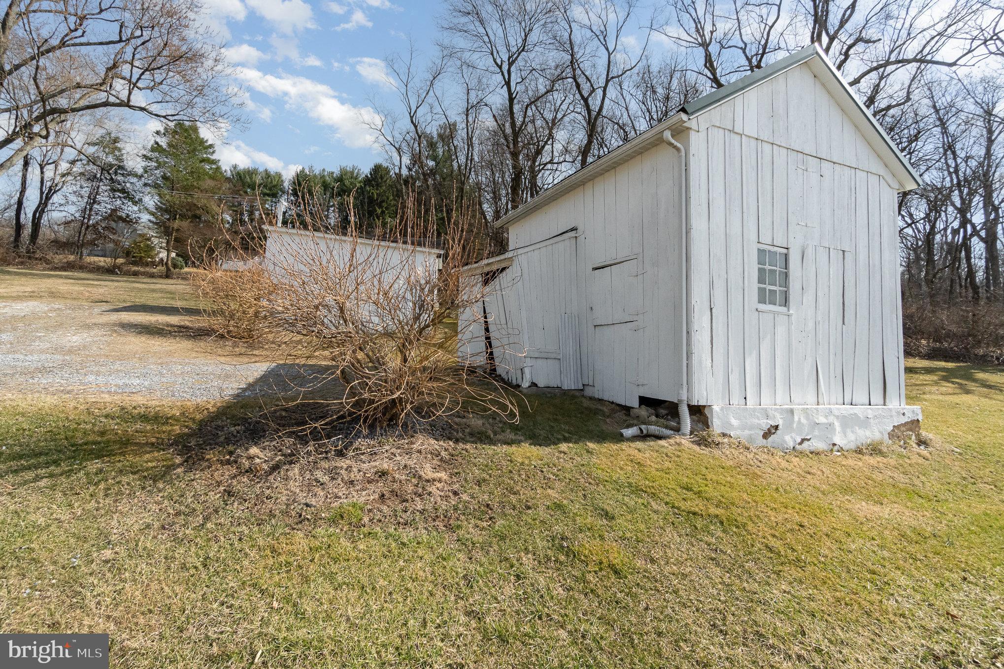 5446 Stambaugh Road Spring Grove, PA 17362 - Photo 22 of 28 Charming white shed nestled in serene landscape.