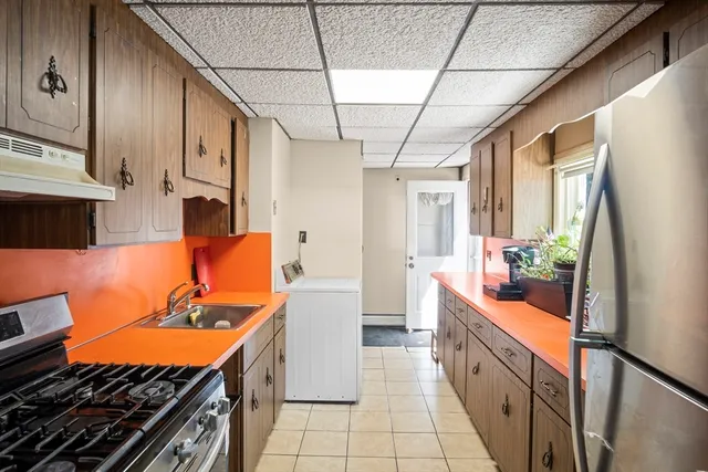 a large kitchen with stainless steel appliances granite countertop a lot of counter space and a sink