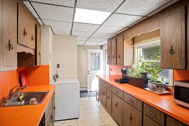 a large kitchen with a sink and cabinets