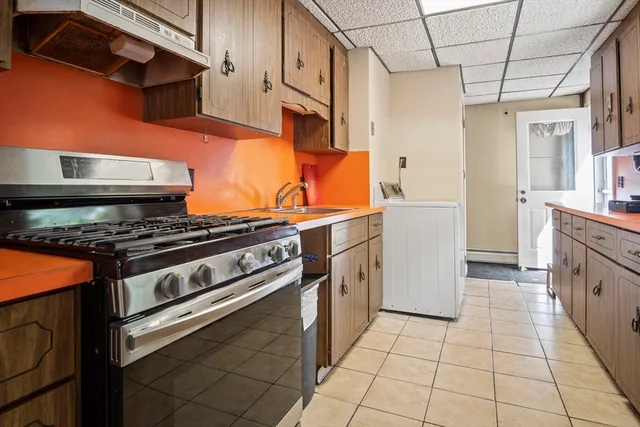 a kitchen with stainless steel appliances granite countertop a stove and a refrigerator