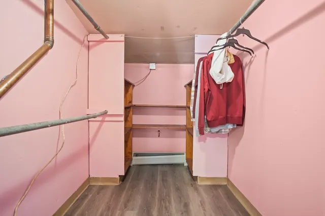a view of walk in closet with clothes and shoes
