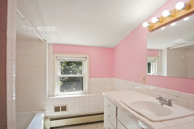 a bathroom with a sink a vanity and a mirror