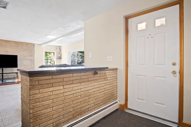 a view of a hallway with closet and mirror
