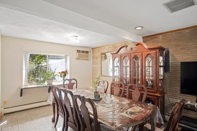 a view of a a dining room with furniture window and outside view