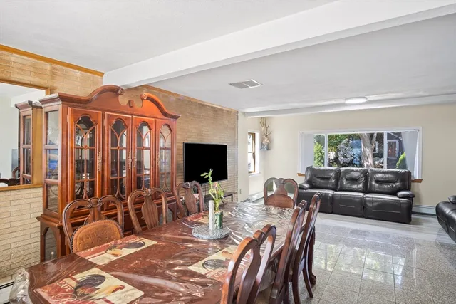 a living room with furniture a rug and a flat screen tv