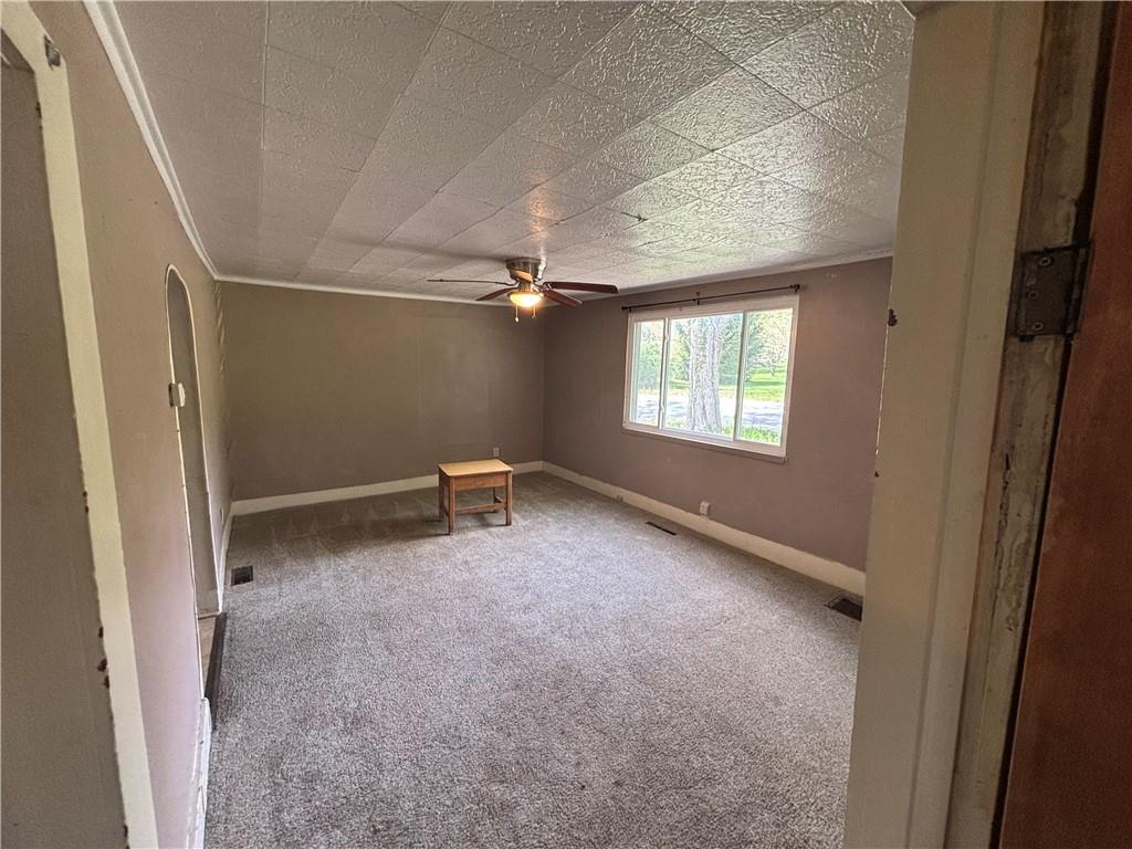 44 Bedford Road West Middlesex, PA 16159 - Photo 4 of 12 an empty room with windows and ceiling fan