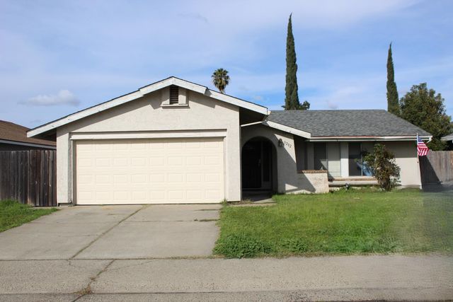 a view of a house with a yard and sitting area