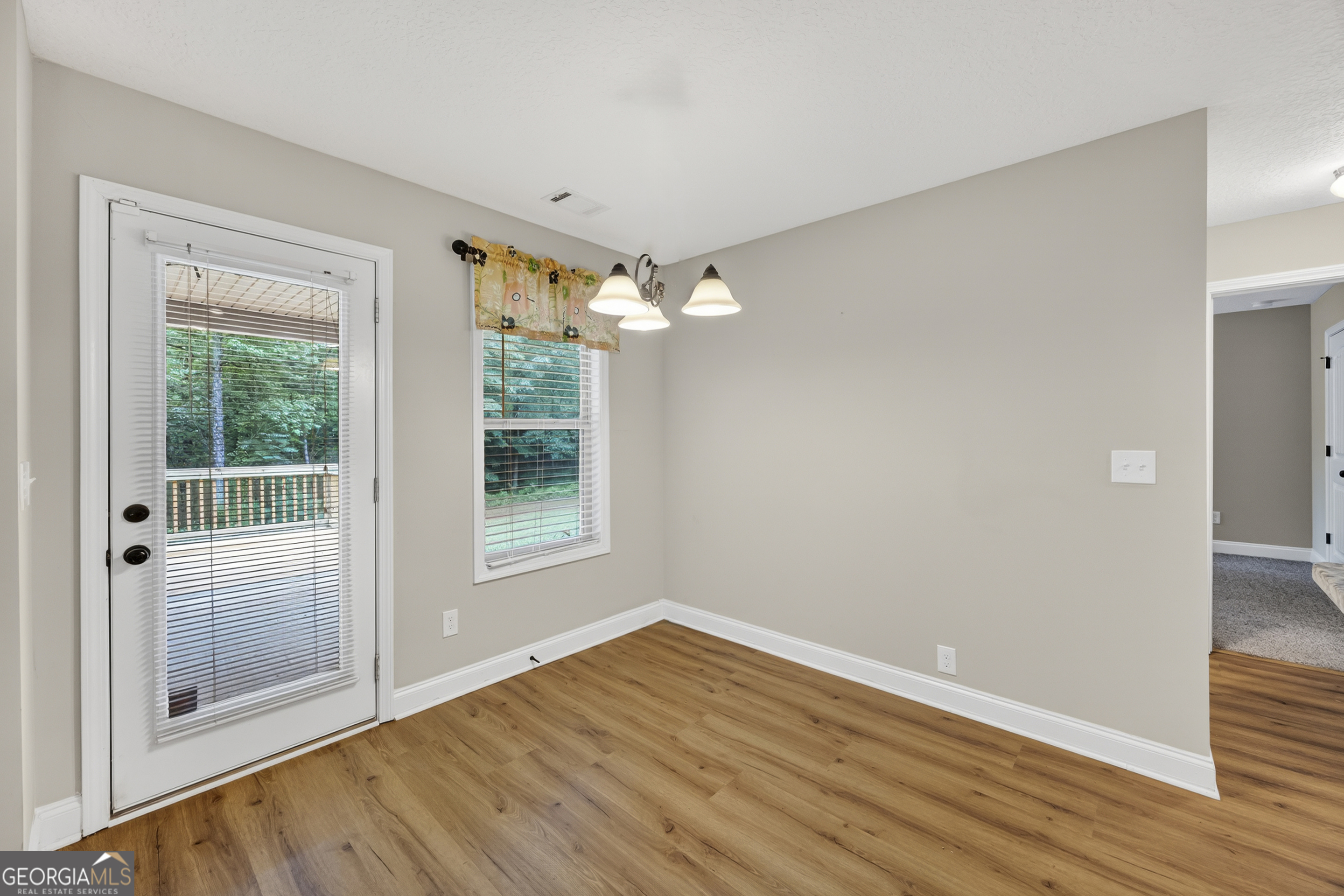 717 Oconee Lane Commerce, GA 30529 - Photo 25 of 57 a view of a big room with wooden floor and windows