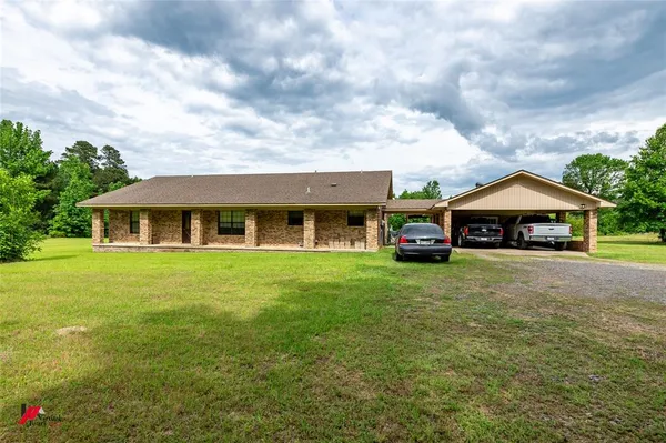 a front view of house with yard and green space