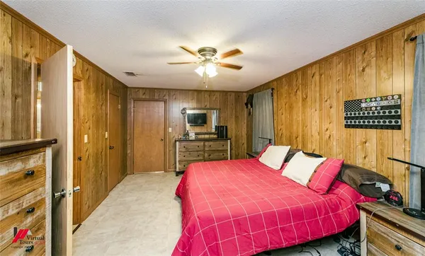 a bed room with a bed and a television