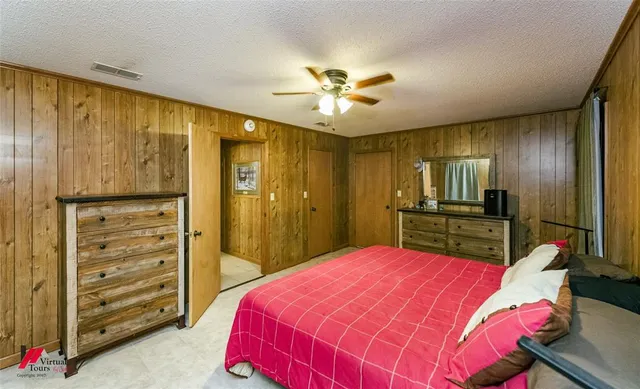 a bed room with a bed mirror and a window