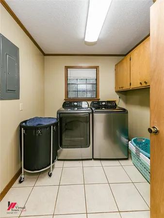 a kitchen with stainless steel appliances kitchen island granite countertop a refrigerator a sink a stove and white cabinets