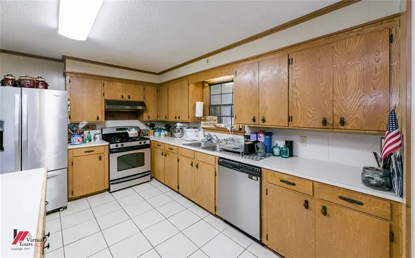a kitchen with a stove a refrigerator and a sink