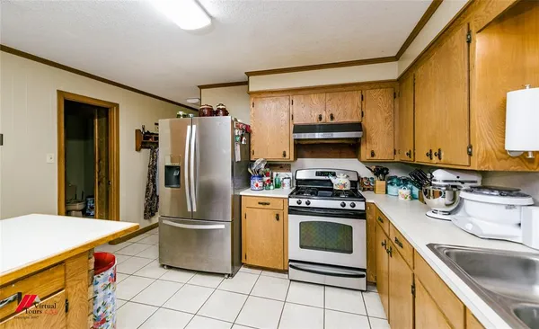 a kitchen with stainless steel appliances granite countertop a sink and cabinets
