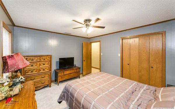 a bedroom with a bed and a chandelier