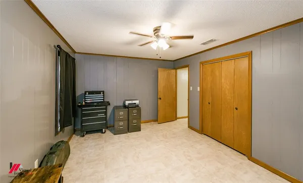 a spacious bathroom with a granite countertop sink a mirror and a bathtub