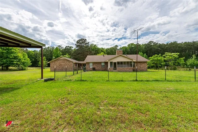 a view of a house with a backyard