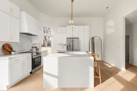a kitchen with cabinets and stainless steel appliances