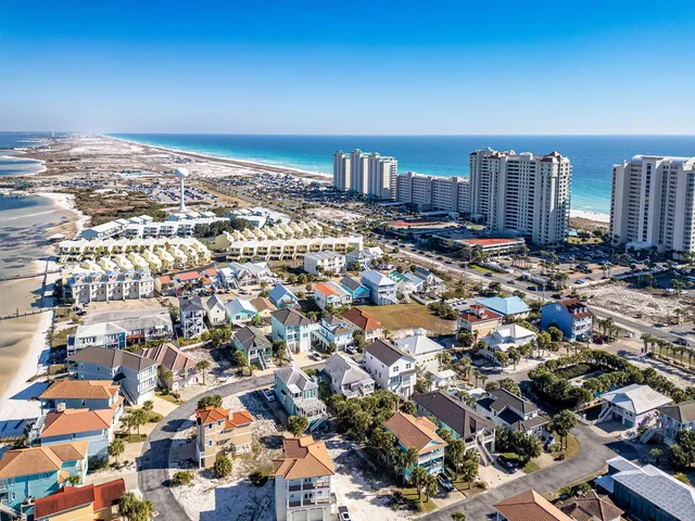 a kitchen with stainless steel appliances granite countertop a table chairs sink refrigerator and cabinets