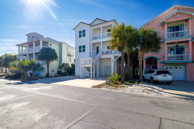 an aerial view of a house with table and chairs