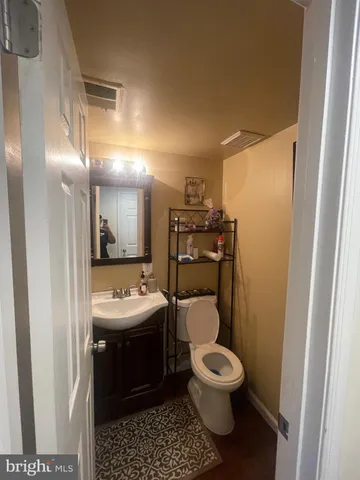 a bathroom with a toilet sink and mirror