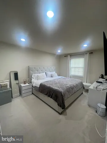 a spacious bedroom with a bed and window