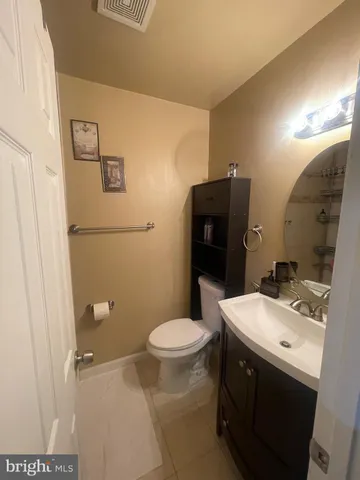 a bathroom with a sink toilet and mirror