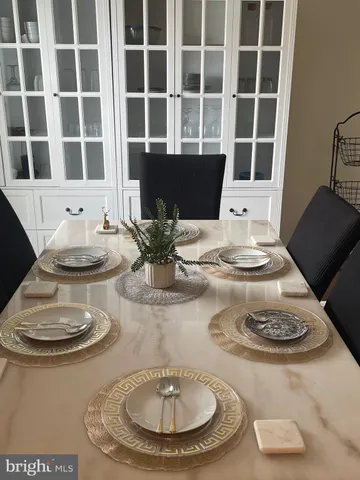a dining room with table and chairs
