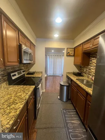 a kitchen with a stove microwave and sink