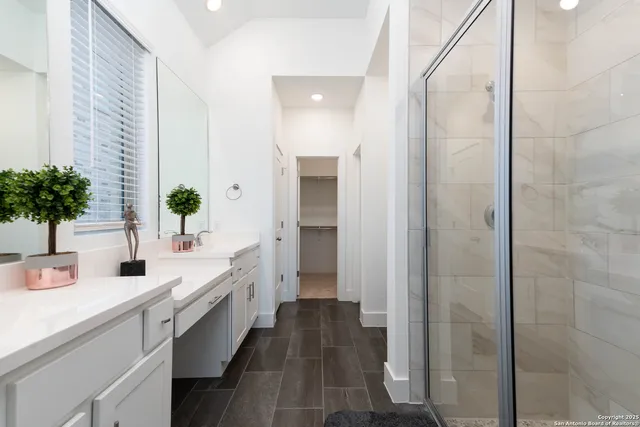 a bathroom with a double vanity sink and a mirror
