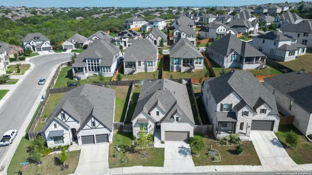 an aerial view of a house with a yard